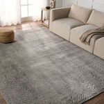 Dune rug styled in living room setting with beige sofa and natural light