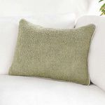 Pillow styled on white sofa, showing cozy decorative layering effect