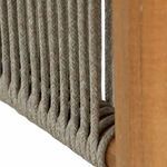 Close-up of tightly braided gray woven rope wrapped around teak frame corner