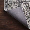 Layla Taupe Stone Rug corner with back lifted to reveal woven non-slip backing on hardwood