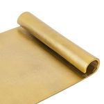 Close-up on curled scroll edge showing textured raw brass metal finish of aluminium tray