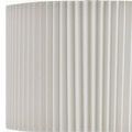 Close-up of off-white knife-pleated fabric lamp shade with brass detail visible below