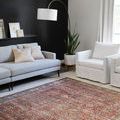 Layla Brick / Blue Rug styled in living room with light gray sofa and white armchair