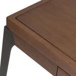 Close-up on corner showing wood grain edge detail and textured black iron leg