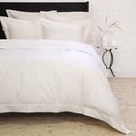 Ivory cotton sateen duvet set with intricate hemstitch borders on a Twin-sized bed styled with matching pillow shams