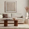 Lira Bowl placed on wooden coffee table in a modern living room setup with a beige couch and wall art