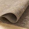 Louisa Taupe / Gold rug rolled at one edge to show velvet-like polyester pile texture