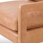 Detailed view of inner armrest seam and cushion edge on butterscotch leather chair