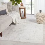 Jovie Abstract Rug styled in bright modern living room with sofa, pillows, and natural light