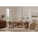 Dining room scene with Mikoshi table surrounded by beige upholstered armchairs on rug