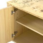 Interior view of cabinet door open revealing adjustable wooden shelves and metal hinges