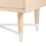 Detail of tapered wooden legs with silver metal caps and crisscross metal base support