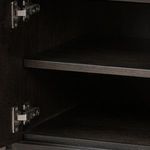 Interior close-up of shelving and door hinges inside the Dalton Media Console
