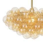 Side angle close-up showing overlapping amber glass globes with light glowing from center