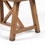 Close-up of leg and X base junction showing wood texture and wax finish with darkened foot accents