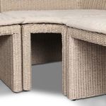 Partial view of banquette corner showing inward curve and cushioned neutral seat