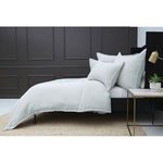 Side view of Waverly duvet set on bed with black paneled wall and brass lamp on bedside table