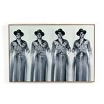 Black and white photograph of Ronald Reagan in cowboy attire repeated four times with a blurred lower half, framed in wood