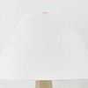 Close-up on plain white tapered linen lampshade top section