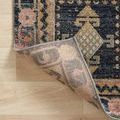 Corner of Jocelyn rug flipped to reveal tightly woven backing construction and edge binding