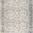 Darling area rug with a traditional pattern in charcoal, beige, and soft blue tones with a distressed finish.