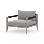 Outdoor chair with weathered grey teak frame and textured ash Sunproof fabric cushions in grey