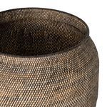 Basket with a knitted cream throw inside, viewed from the top-side angle