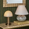 Close-up of La Gravite Mini Table Lamp styled next to a patterned table lamp and books