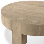 Close-up of table edge showing wood veneer top and dovetail joinery detail on leg