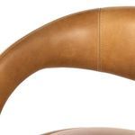 Close-up of backrest curved top and horizontal seam of stool in butterscotch leather