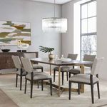 Kaela chandelier hanging over dining table in modern dining room with artwork and chairs
