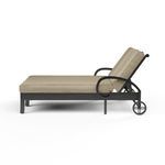 Side view highlighting adjustable backrest reclining position and chaise wheels on Monterey Double Chaise