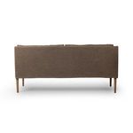 Back view showing streamlined oak legs and smooth linen upholstery on banquette
