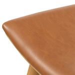 Close-up showing smooth texture and warm tone of the padded leather seat