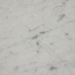 Close-up from below showing curved marble top and connection to curved brown acacia leg