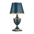 Travelogue lamp angled right with scalloped navy shade and gold painted body accents