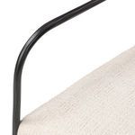 Side detail showing smooth curve of black iron frame armrest against upholstery