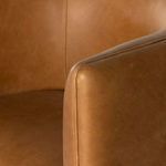 Detailed close-up of armrest seam and leather surface texture