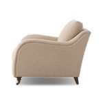 Side view of Lynne Chair showcasing the sloped backrest and turned front casters