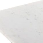 Terrell End Table with focus on angular leg detail and marble surface corner