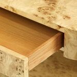 Open drawer revealing light oak wood interior of the side table