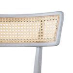 Detail of bleached octagonal cane woven pattern within curved wooden frame