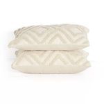 Stacked pair of rectangular outdoor pillows showing high-low diamond pattern on top and sides