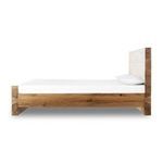 Low angle close-up of bed’s exposed corner joint highlighting precise woodworking