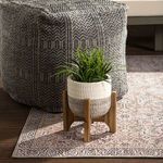 Straight view of rug under outdoor sofa with pillows and lanterns, showcasing full trellis pattern and colors