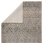 Top view of rug folded corner revealing the light-colored underside backing