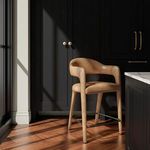 Martens stool placed in kitchen corner next to cabinets and island with wood flooring and natural light