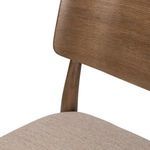 Close-up of upholstery fabric and curved wood backrest junction on Marley Dining Chair