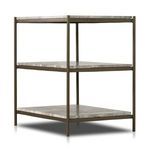 Close-up on top shelves and corner of nightstand highlighting marble texture and brass frame