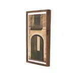 Side angle view showing thick walnut frame depth around framed photo of rustic arched door and balcony